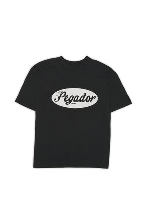 Black cotton T-shirt featuring a large white oval logo with the text "Pegador" in a cursive style, short sleeves, and a round neckline.