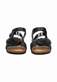 Black sandals with a cork sole, featuring a leather strap design, metallic accents, and a textured flower detail on the side.