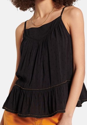 Haut sans manches noir avec une coupe décontractée, tissu texturé, ourlet volanté, et petites accents dorés le long du bord inférieur.