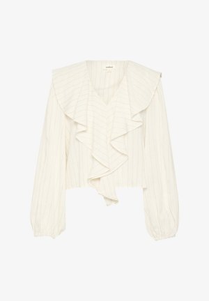 Balta, īsa blūze ar vertikālām svītrām, piedāvājot dziļu V-veida kaklu un ruffle priekšpusi. Garas, pūkainas piedurknes ar elastīgām aprocēm.