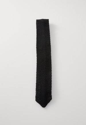 Mustra mustri kootud lips mustas värvitoonis, millel on tekstuuriga viimistlus. Kitsas kuju, terav ots ja ühtlane kudumise muster. Lihtne disain ilma täiendavate aksessuaarideta.