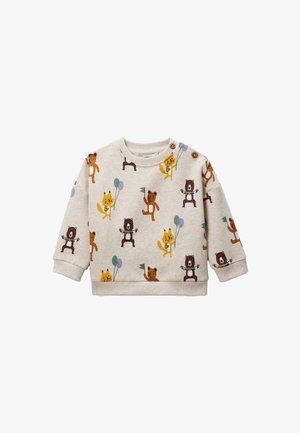 Sweatshirt beige clair avec des motifs d'animaux ludiques en orange, marron et jaune. Encolure arrondie avec deux boutons-pression sur l'épaule.
