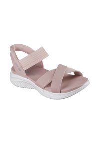 Sandal de color rosa claro con correas cruzadas de tela elástica, suela acolchada y una suela exterior de goma blanca texturizada. Diseño plano, con puntera abierta.