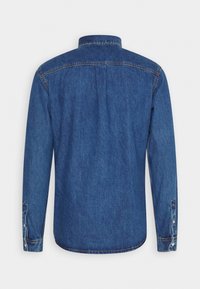 Denimskjorta i medelblått, långärmad, med knappmanschetter och klassisk krage. Har en ryggsöm med stickdetalj och standard nederkant.