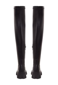 Botas de cuero negras por encima de la rodilla con un diseño elegante, cremalleras laterales y suelas de goma gruesa. Textura suave, que llega a mitad del muslo.