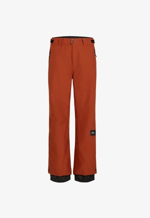 Πορτοκαλί αδιάβροχες παντελόνες σκι με μαύρη ρυθμιζόμενη μέση, πλαϊνές τσέπες και ελαστικές μανσέτες για ρύθμιση της θερμοκρασίας.