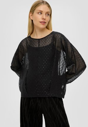 Schwarzes, transparentes Oberteil mit gepunkteter Textur, weitem Ärmeldesign, rundem Ausschnitt und subtiler Glitzerung. Weicher Stoff, geschichtetes Design für ein leichtes Erscheinungsbild.