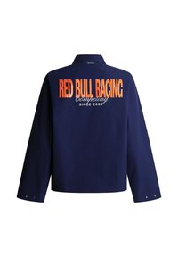Μακρυμάνικο μπουφάν σε ναυτικό μπλε με πορτοκαλί κείμενο "RED BULL RACING" και λευκό κείμενο "Competing since 2004" στην πλάτη.