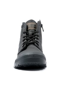 Sneaker alta nera con tessuto texture, suola in gomma spessa e lacci anteriori. Presenta una cerniera laterale e un'etichetta con il marchio sulla linguetta.