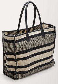 Sac fourre-tout rayé en tissu tissé avec des rayures noires et crème. Dispose de poignées en cuir noir et d'une forme structurée.