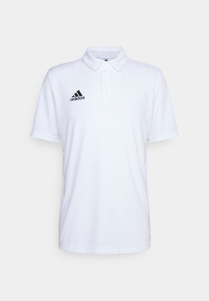 Balta polo krekla izgriezums no kokvilnas maisījuma, ar pogu apkakli, īsām piedurknēm un melnu Adidas logotipu uz krūtīm.