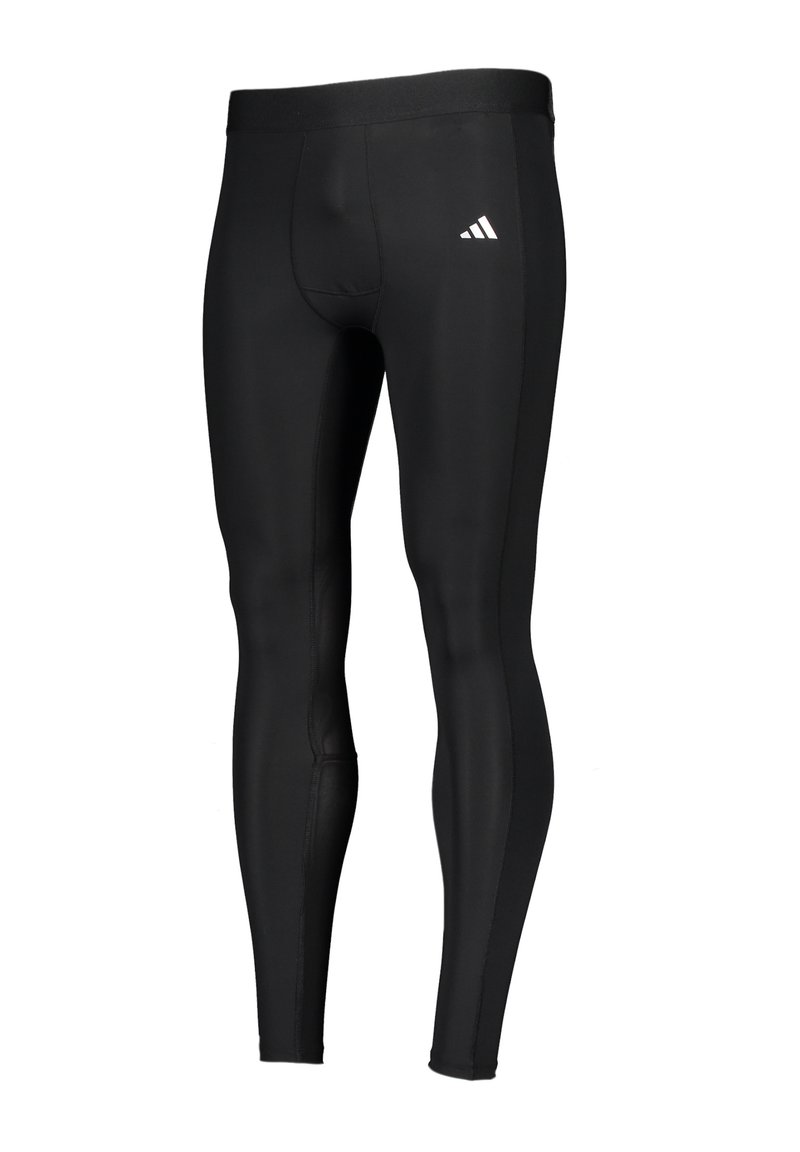 Zwarte sportleggings van rekbaar materiaal, met een getailleerd ontwerp en een elastische tailleband. Klein wit logo aan de zijkant.