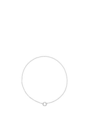 Delicate silver chain necklace with a small circular clasp centered at the front on a plain white background.