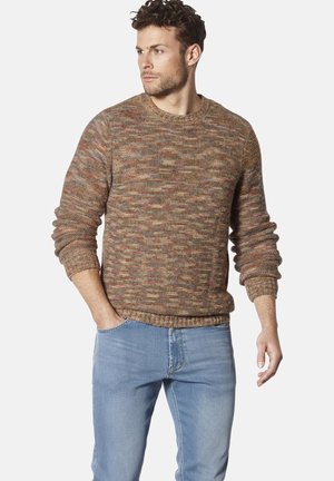 Brown textured knit sweater with a crew neckline and ribbed cuffs, featuring a multicolored pattern. Paired with light blue jeans.