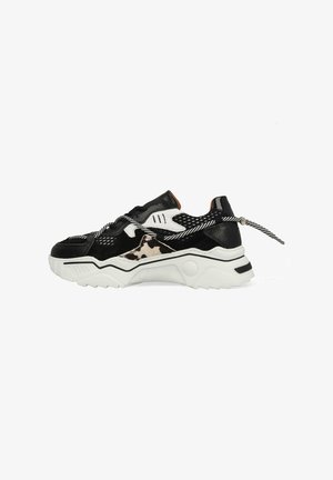 Zwart-witte chunky sneaker met een dierenprint zijpaneel, textuurmaterialen en zwart-wit gestreepte veters die bij de hak zijn vastgebonden.