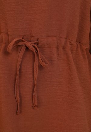 Brown fabric with a textured finish; features a drawstring waist tie and elastic at the top for adjustable fit.
