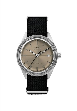 Timex Marlin automatic watch with a beige dial, silver hour markers, and a black woven strap. Features a date window and stainless steel case.