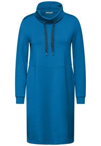 Sininen pitkähihaine mekko, jossa on käännekaulus, säädettävät nauhat ja sileä pinta; sisältää kaksi sivutaskua.
