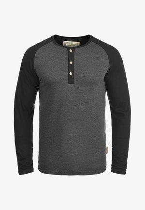 Langärmliges Henley-Shirt mit einem dunkelgrauen Körper und schwarzen Raglanärmeln. Verfügt über drei Holzknöpfe am Ausschnitt und einen strukturierten Stoff.