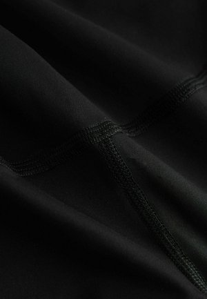 Black fabric with a smooth texture and visible stitching. Features curved seams and a matte finish, creating a sleek and fitted appearance.