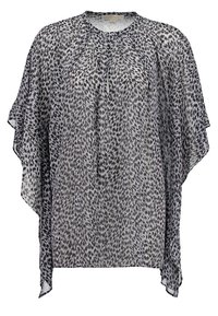 Blouse ample à motifs noir et blanc avec manches larges et petite ouverture ronde au niveau du col.