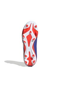 Suela de zapato con un diseño predominantemente blanco, con clavos de tracción rojos y naranjas, superficie texturizada y una forma aerodinámica.