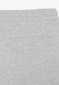 Gray, soft cotton fabric with a stitched waistband and a small, rectangular patch pocket detail. Smooth texture and simple design.