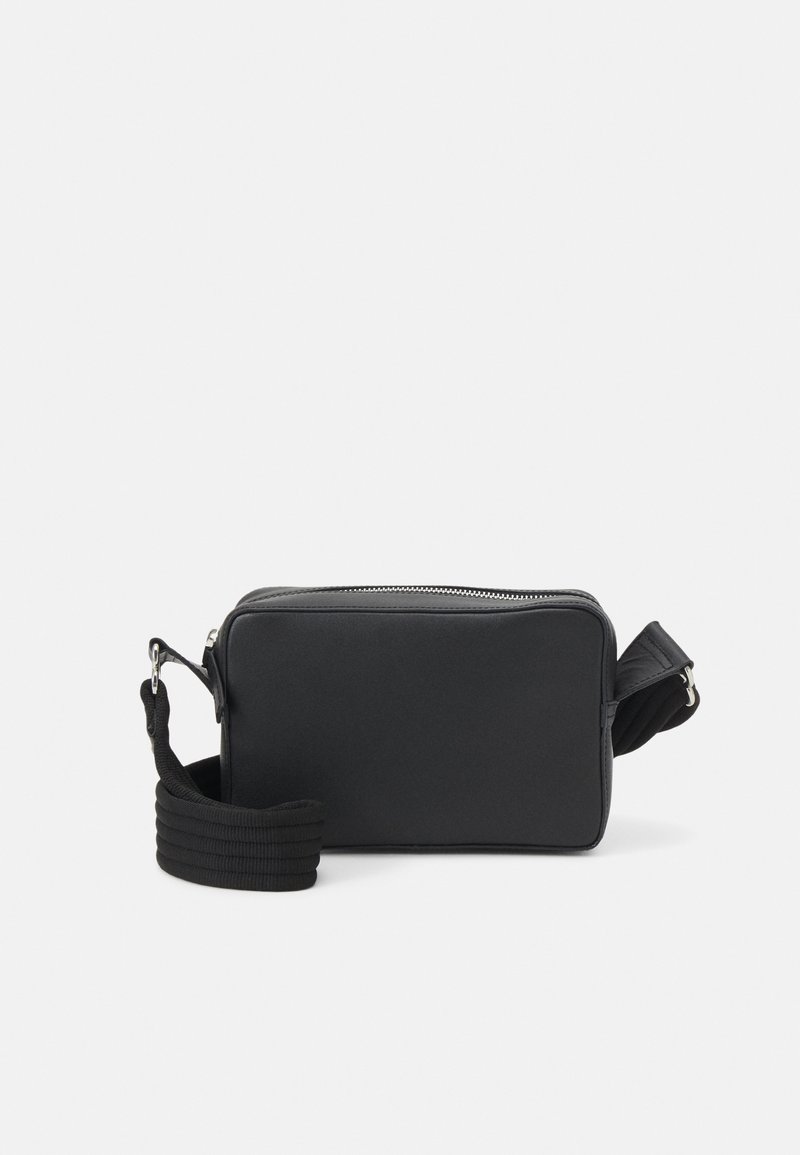 Black rectangular crossbody bag with silver zipper and wide adjustable strap placed on white background.