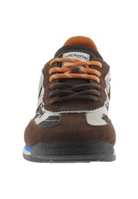 Brown suede sneaker with a white and gray camo design, orange laces, and a black rubber sole with blue accents. Features logo on tongue.