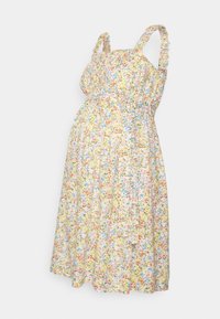 Kwiatowa sukienka ciążowa w delikatnym żółtym kolorze. Posiada falbaniaste ramiączka oraz elastyczny pas. Wzory obejmują różowe, niebieskie i zielone kwiaty.