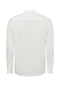White long-sleeve shirt made of lightweight linen, featuring a straight back seam, button cuffs, and a rounded hem.