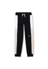 Schwarz-weiße Sweatpants mit beige Akzenten, gekennzeichnet durch einen Kordelzug-Bund, elastische Bündchen und ein Logo an dem Unterschenkel.