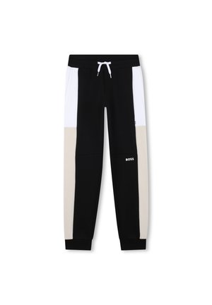 Pantalons de survêtement noir et blanc avec des accents beige, dotés d'une taille avec cordon de serrage, de poignets élastiques et d'un logo sur la jambe inférieure.