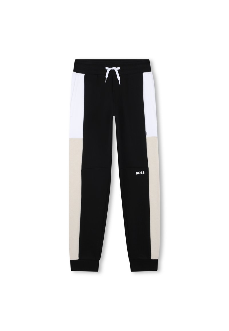 Schwarz-weiße Sweatpants mit beige Akzenten, gekennzeichnet durch einen Kordelzug-Bund, elastische Bündchen und ein Logo an dem Unterschenkel.