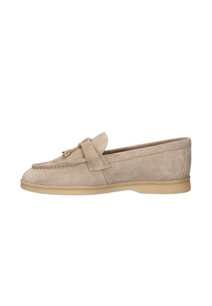 Beige suede loafer with low rubber sole, stitched detailing, and a decorative strap with metal accents on top.