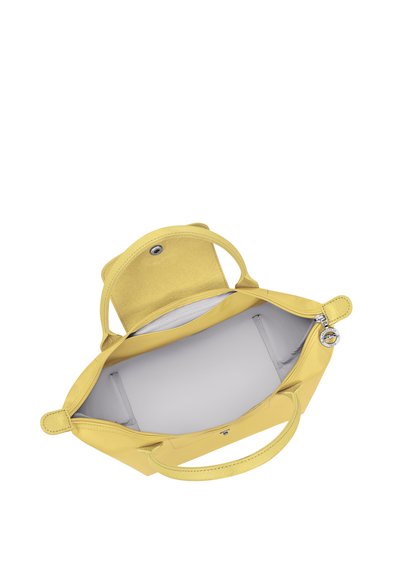 Yellow handbag with two handles, open top flap, visible silver zipper pull, and spacious light gray interior.
