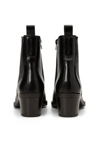 Black leather ankle boots with a smooth finish, side zippers, and a block heel. The back features embossed logo detailing.