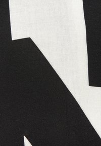 Black and white fabric with a bold geometric pattern, featuring contrasting shapes and a smooth texture. Suitable for various textile applications.