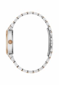 Ceas argintiu și auriu, cu un carcasă metalică netedă, sticlă curbată și un design cu brățară cu verigi. Dispune de un cadran rotund și detalii cu logo.