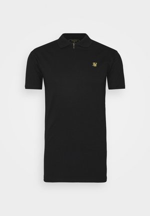 Zwart poloshirt van gladde stof, met een korte rits en een klein gouden logo op de borst. Klassieke kraag en korte mouwen.