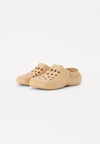 Beige clogs with ventilation holes, made of lightweight plastic. Features a back strap and textured sole for grip.
