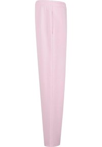 Lys rosa joggebukser laget av mykt stoff, med elastisk midjebånd og sidelommer, i rett ben-design uten synlige mønstre.