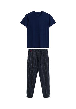 Granatowa bawełniana koszulka z okrągłym dekoltem, w zestawie z granatowymi spodniami dresowymi we wzory w kolorowe kropki oraz elastycznym pasem.