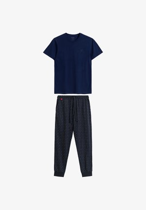 Granatowa bawełniana koszulka z okrągłym dekoltem, w zestawie z granatowymi spodniami dresowymi we wzory w kolorowe kropki oraz elastycznym pasem.