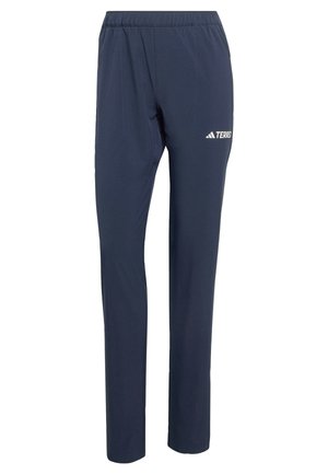 Marineblaue Sporthosen aus leichtem Material, mit elastischem Bund und einem weißen "TERREX"-Logo an der Seite.