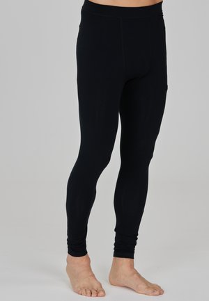 Svarta leggings gjorda av ett mjukt, stretchigt tyg; ankle-length med en åtsittande passform och ett elastiskt midjeband, minimal sömnadsdetalj.