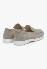 Zamszowe buty slip-on w jasnoszarym kolorze z białymi gumowymi podeszwami, z delikatnym haftem i otwartym piętą dla łatwego zakładania.