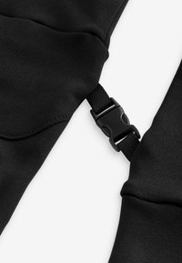 Black fabric straps with a smooth texture, featuring a plastic buckle clasp for secure fastening. Clean edges and minimal design.