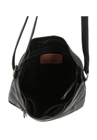 Borsa a mano in pelle nera con chiusura a zip, tasche interne a soffietto e fodera in tessuto. Presenta una lunga tracolla e un patch con logo impresso.
