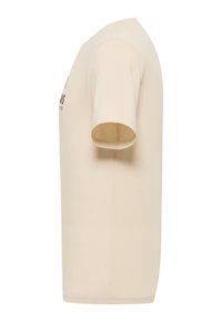 Beige cotton t-shirt with short sleeves, featuring a round neckline and printed design on the front. Smooth texture with a regular fit.